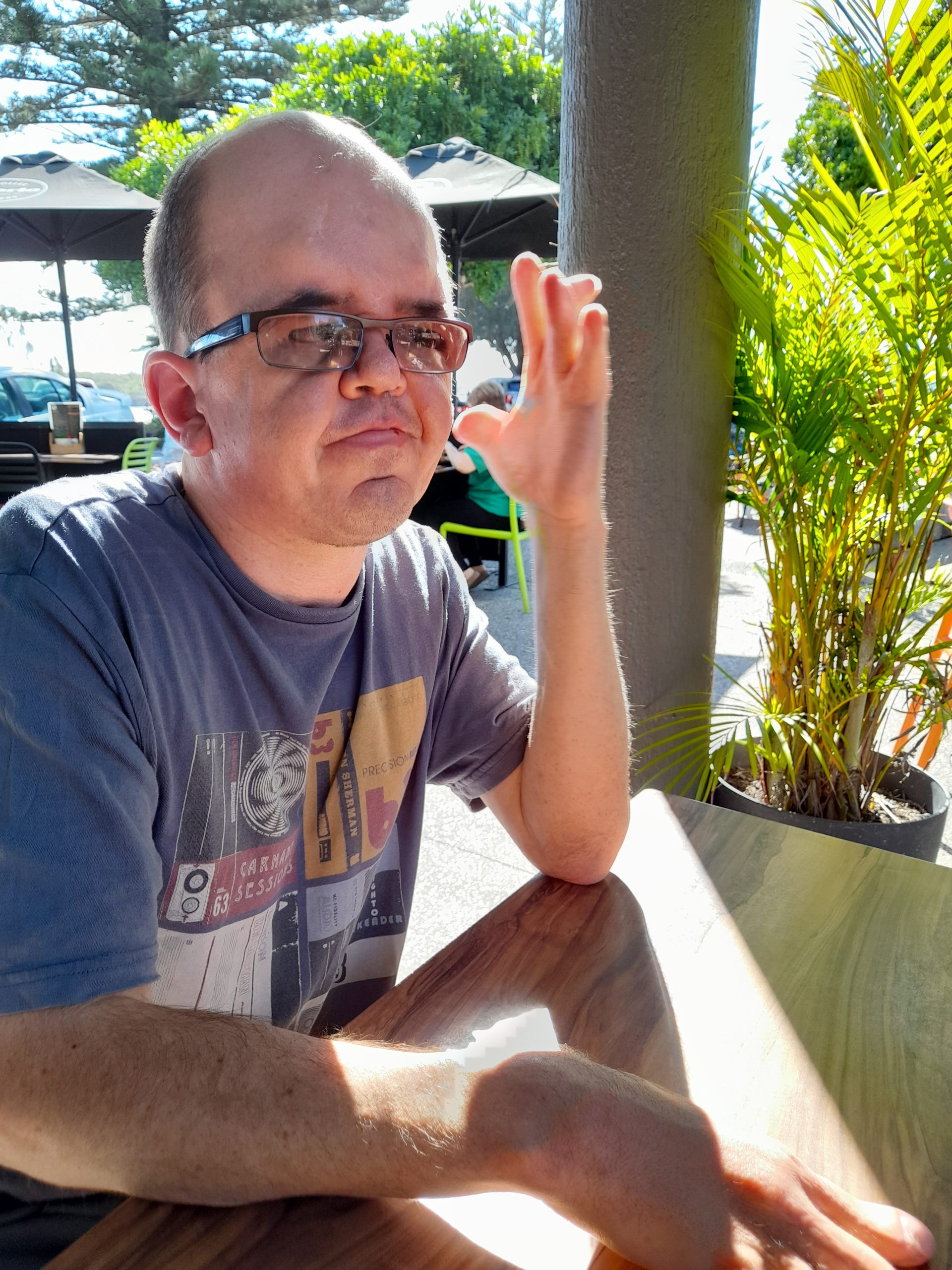 Man with Apert syndrome sitting outdoors