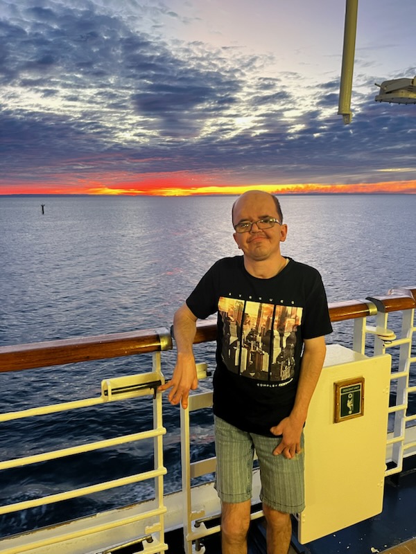Man with Apert syndrome sitting at the seaside