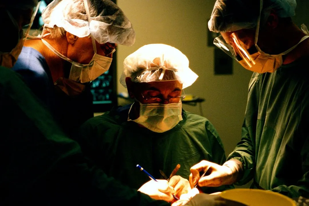 Surgical team performing craniofacial surgery in an operating room.