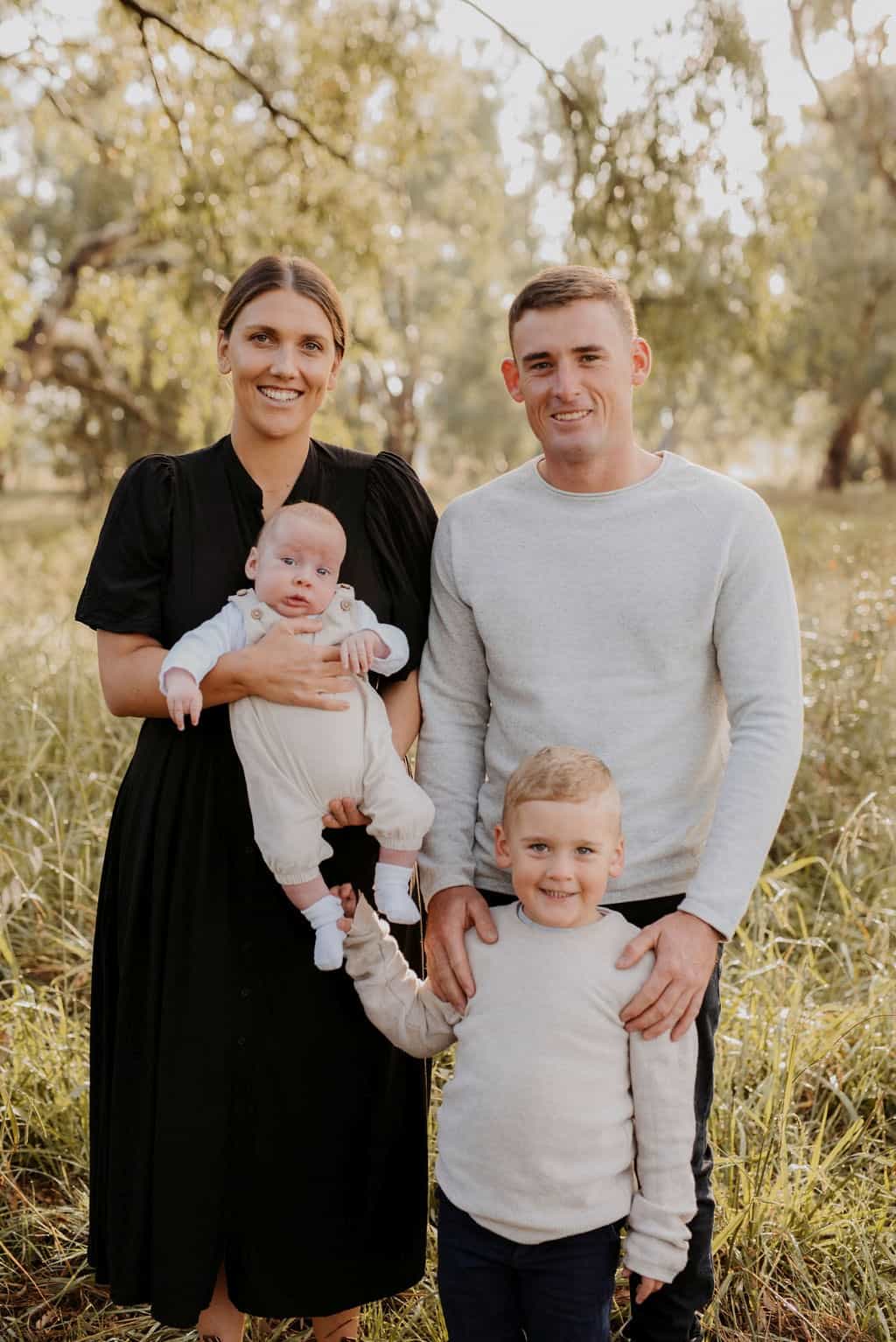 Baby with sagittal synostosis with family outdoors
