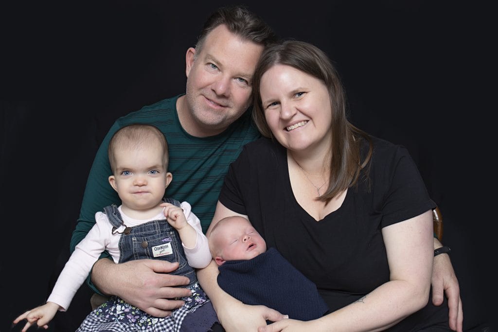 Little girl with Noonan syndrome and sagittal synostosis with her parents