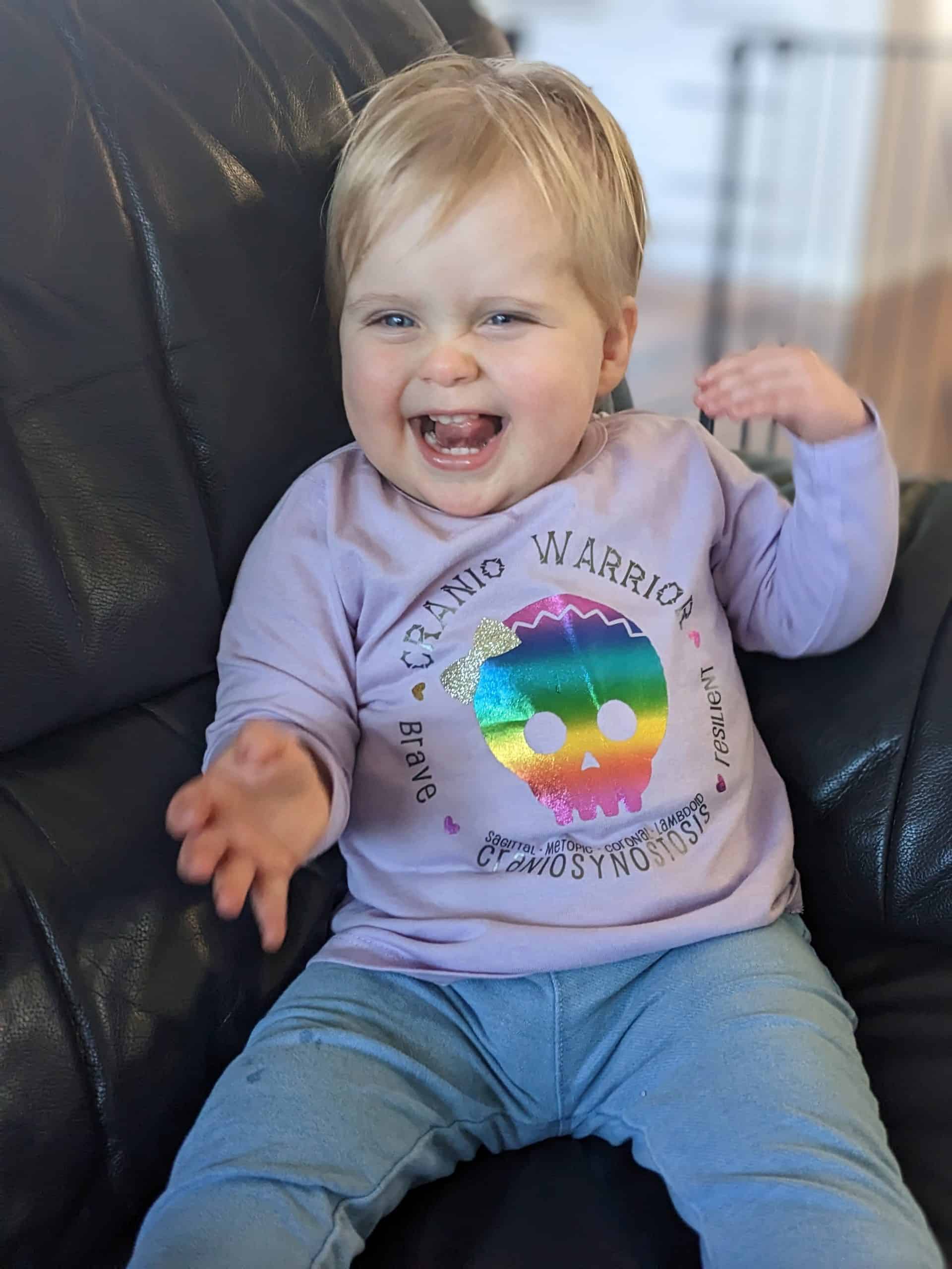 Little girl with sagittal synostosis wearing Cranio Warrior t-shirt
