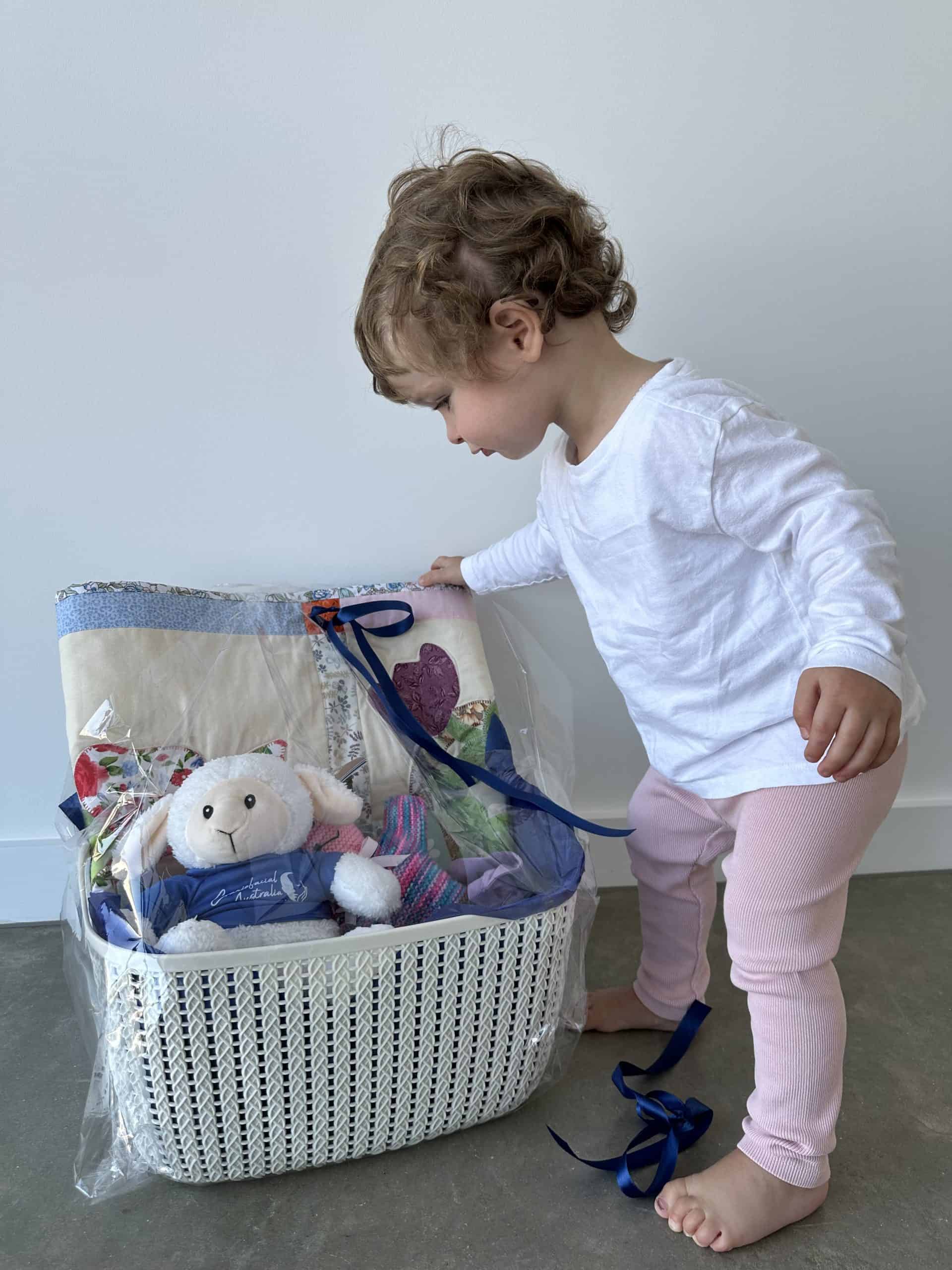 Little girl with sagittal synostosis looking into a toy box
