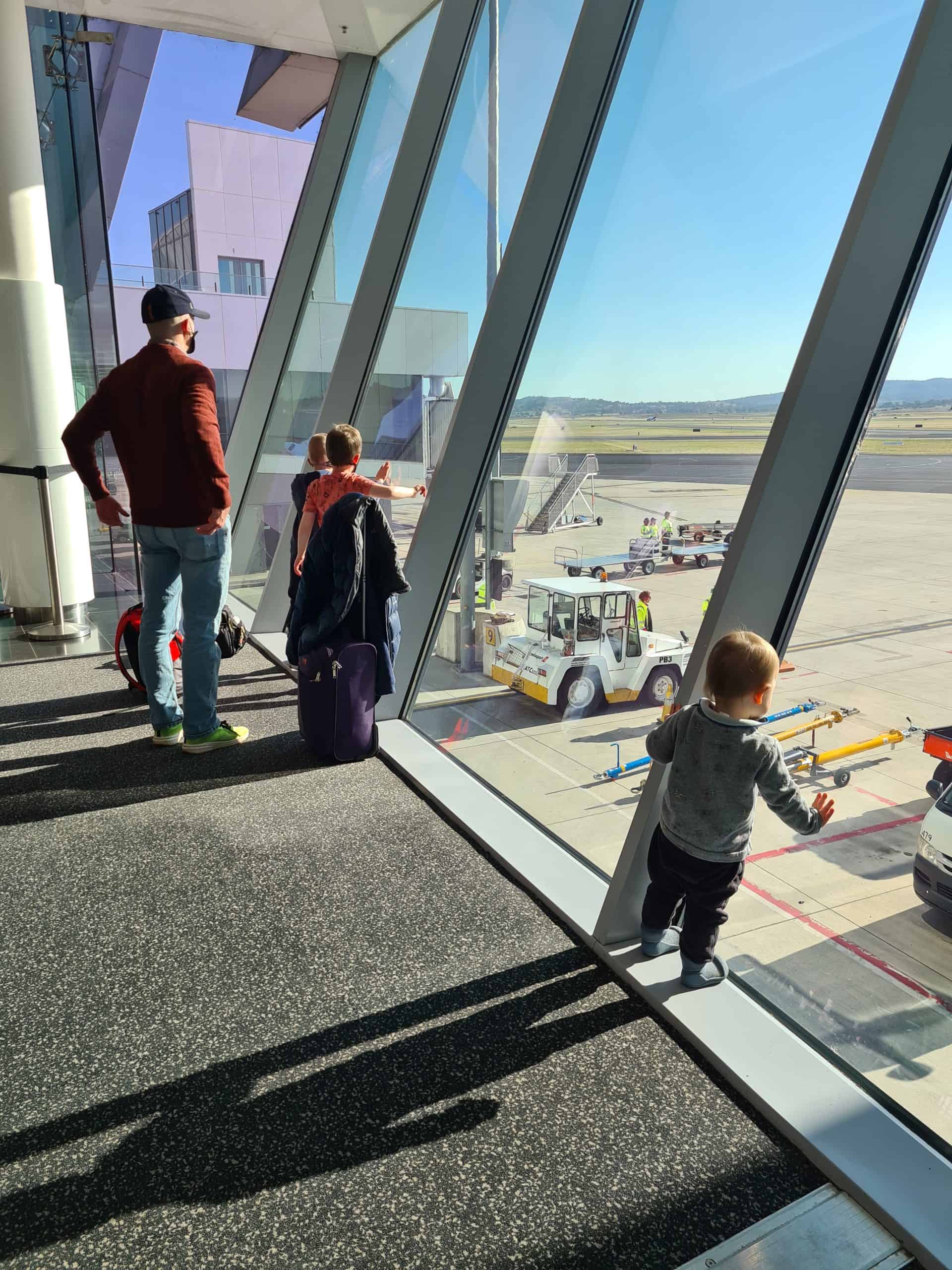 Little boy with sagittal synostosis with family standing in an airport