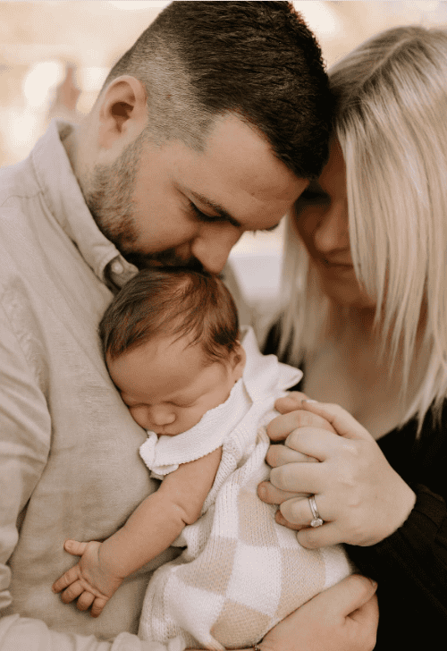 Baby with sagittal synostosis held by his parents