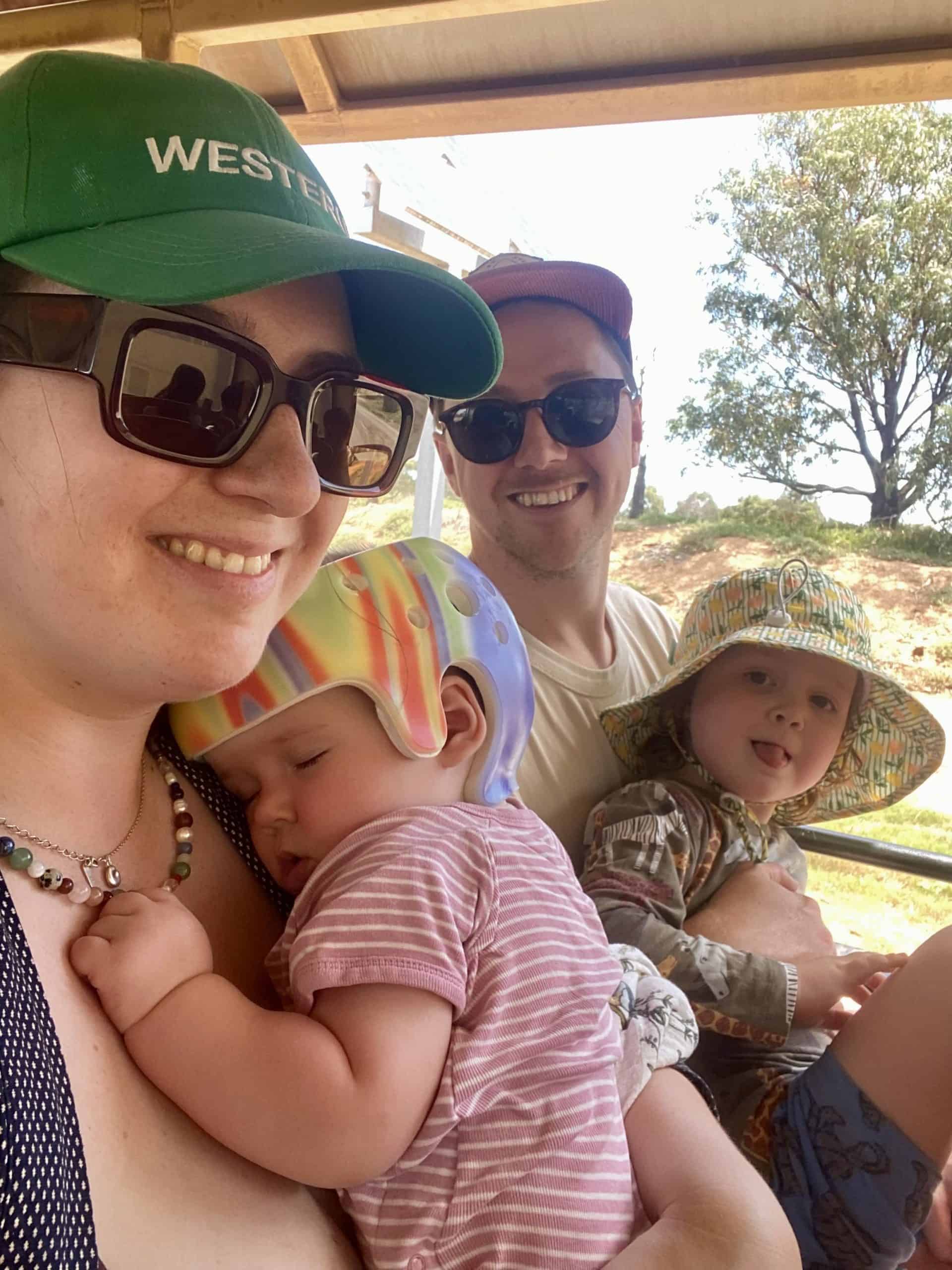 Baby boy with sagittal synostosis outdoors with his parents