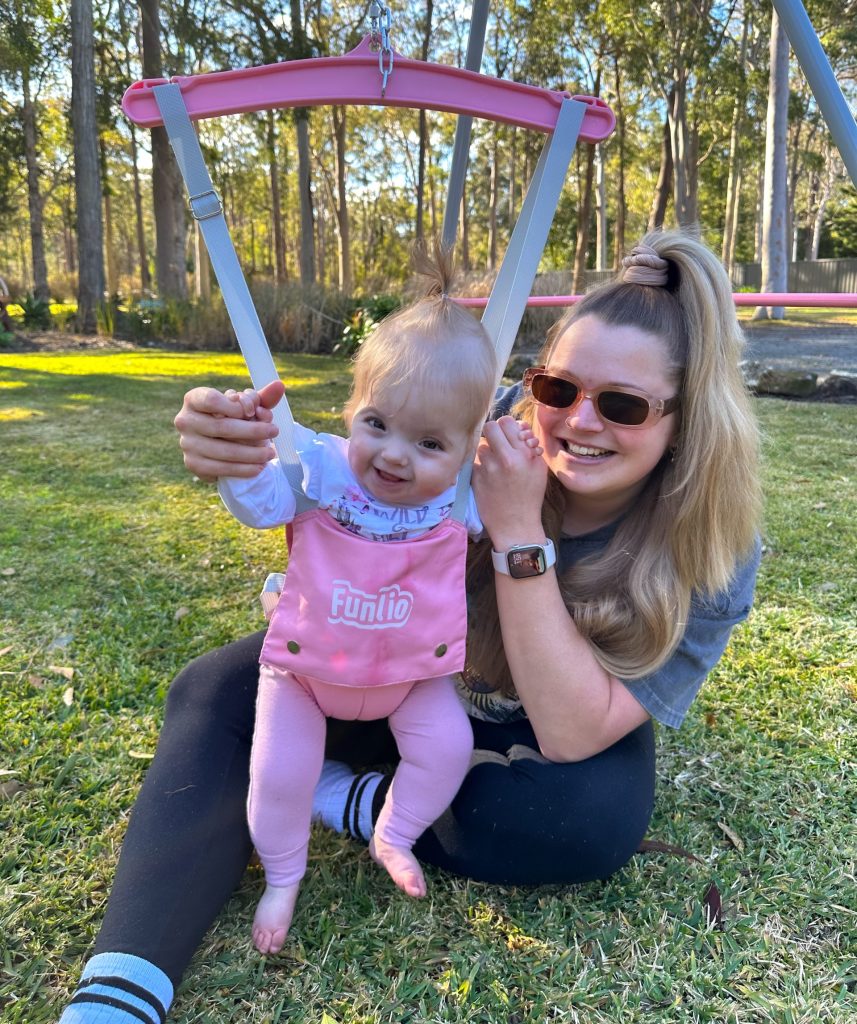 Girl with lambdoid synostosis and her mother playing outside